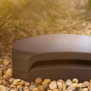 Klipsch-Courtyard-Subwoofer-outside-buried-in-patio-gravel-at-golden-hour-3_2000x1000